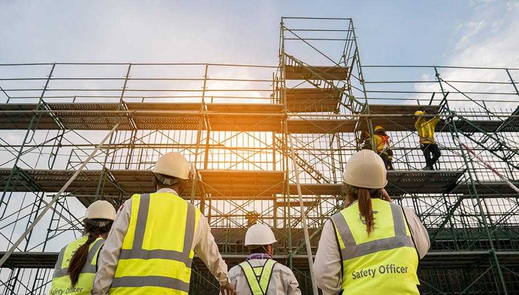 Construction Workers Looking up at Scaffolding