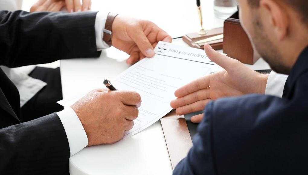 Man pointing at paper being written on