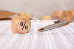 percentage block and various paperwork with numerical caluclations
