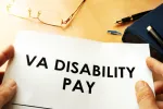 veterans affairs disability pay displayed on pile of papers that someone is holding.