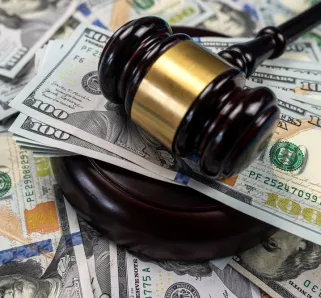 What Damages Can You Sue For - judge hammer with cash