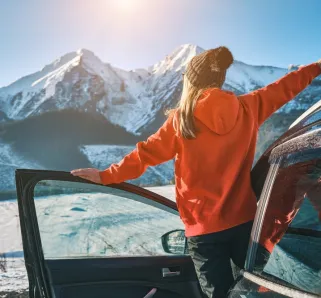 girl driving car in the winter