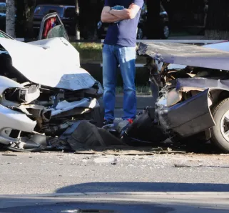 Man looking at two cars after an accident