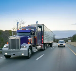 Semi truck driving next to a car