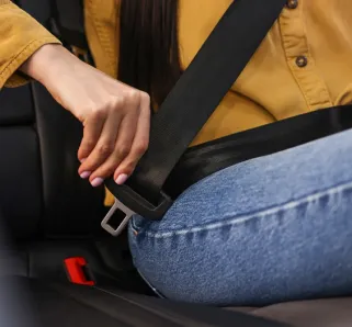 teenager putting on the seatbelt