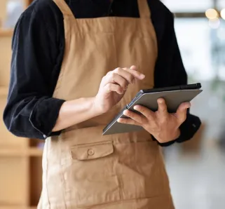 Asian male clerk taking orders at a cafe