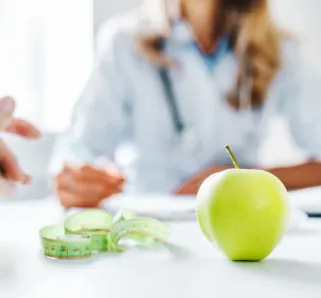 health concept showing people with apple, measuring tape and journal