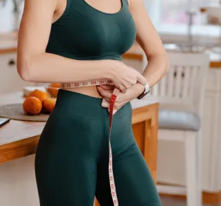 lady with a measuring tape in workout clothing