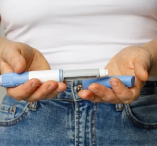 person holding two vaccines