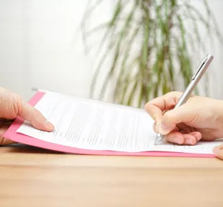 boss gives employee dismissal contract to sign