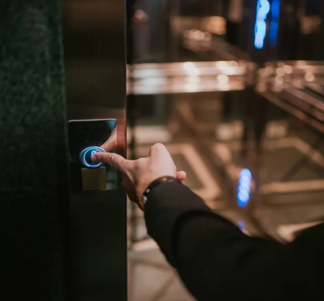 Businessman's finger on the elevator button