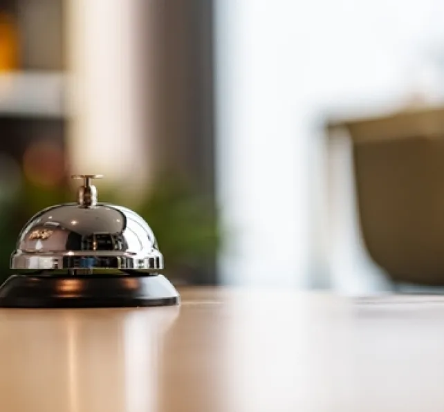 bell on reception desk at hotel