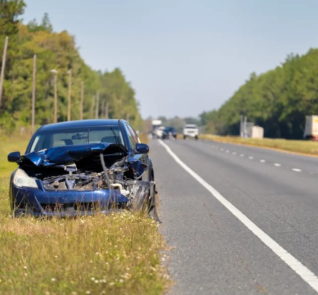 damaged car on the side of the road