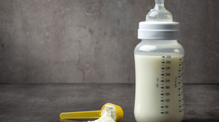 bottle of baby milk on dark grey table