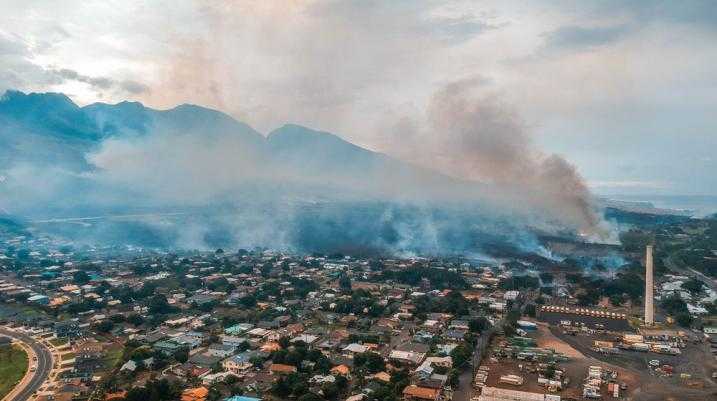 Arial view of smoke rising from a residential area in Maui due to wildfires