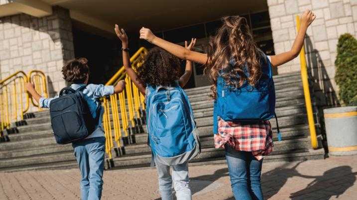 three kids outside of school