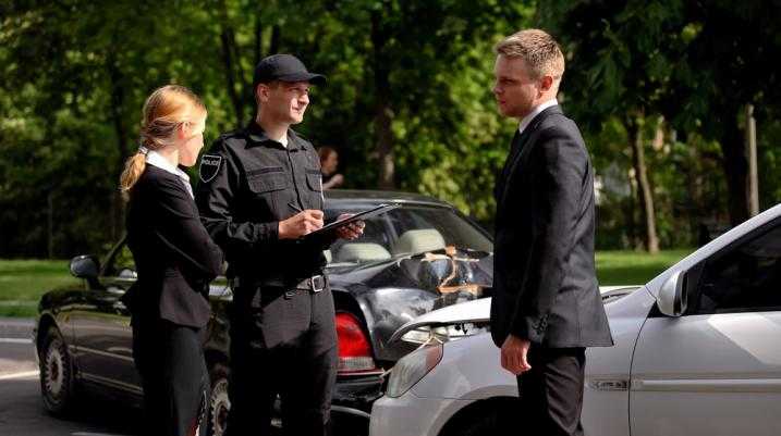 Policeman writing Police Report After an Accident