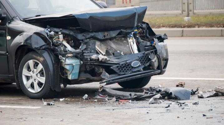 Severely damaged black car