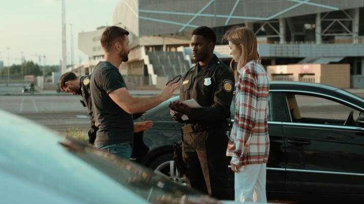 Two people talking to a police officer