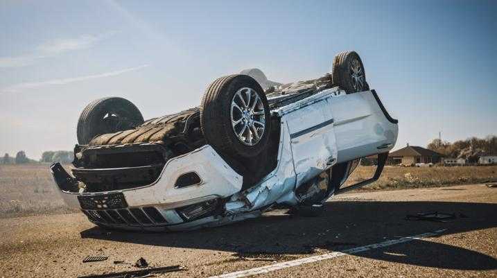 Car flipped upside down on the road