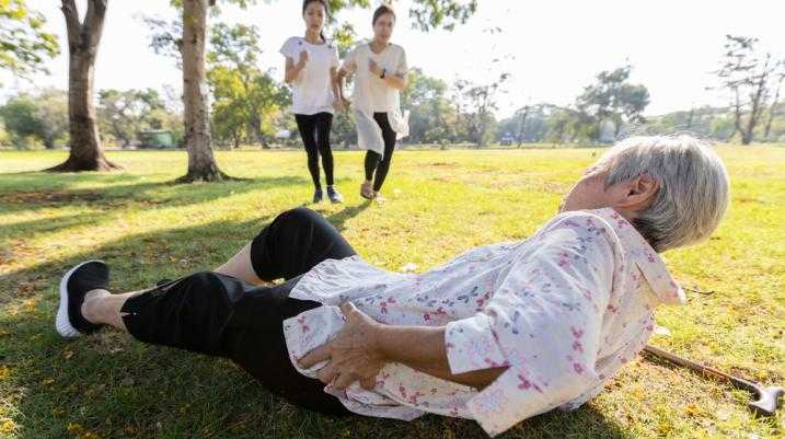 Elderly woman fallen down in a park