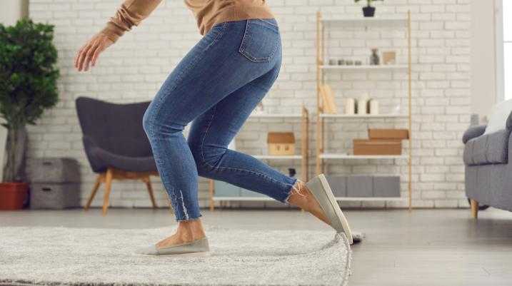 Woman tripping on a rug