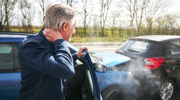 Man holding neck in pain after a car accident