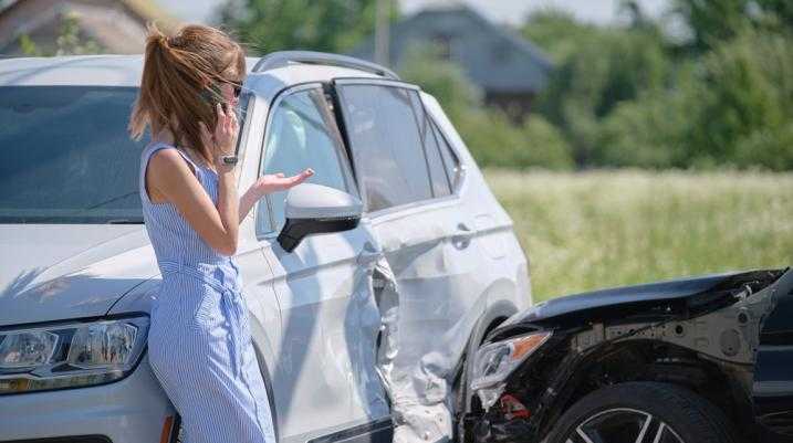 Woman on the phone after a car accident