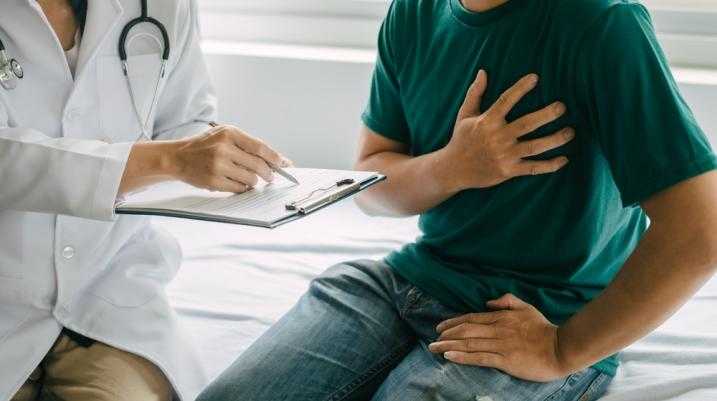 Doctor talking to patient with chest pain