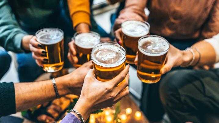 Group of people clinking beers