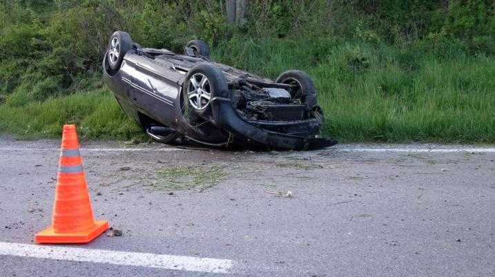 Car flipped upside down on the road