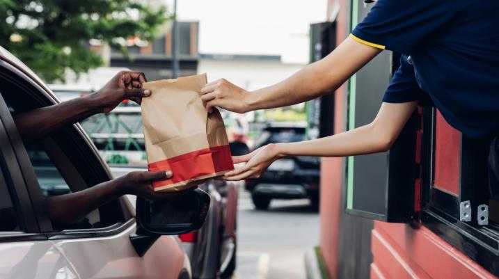 Man in car getting his fast food handed to him