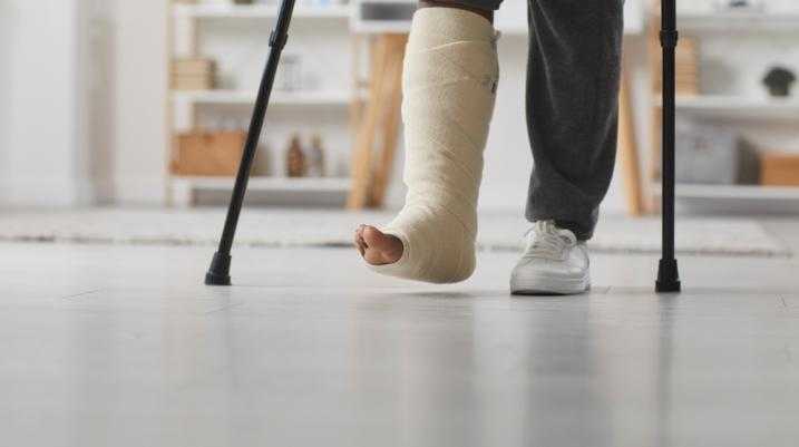 Girl in a leg cast walking with crutches