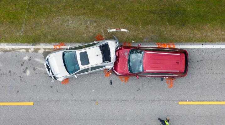 Arial view of a red car crashed into a grey car