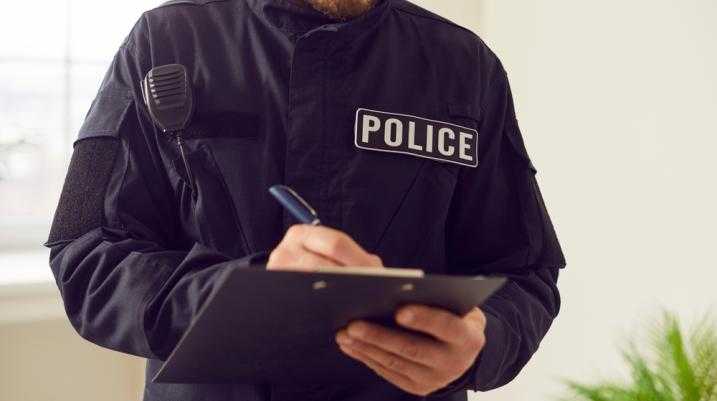 Police office writing on a clipboard