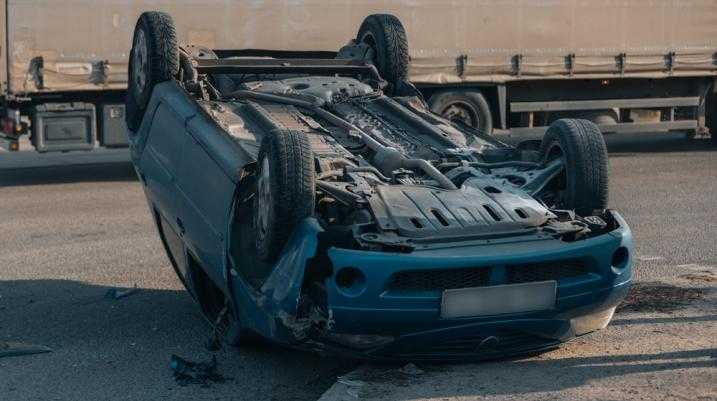 Car flipped upside down on the road