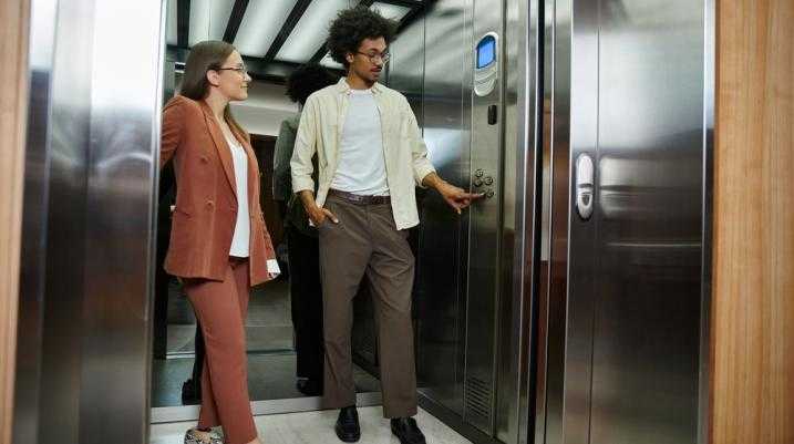 Two people getting into an elevator