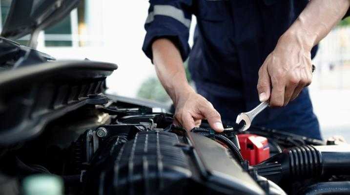 Mechanic fixing a part of a car