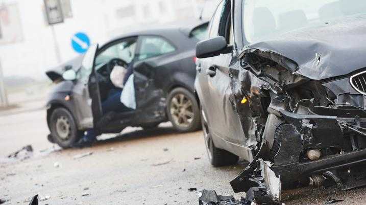 Two black cars with severe damage after an accident