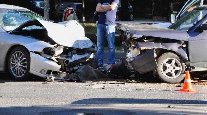 Man looking at two cars after an accident