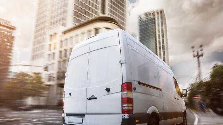 Van driving through a city