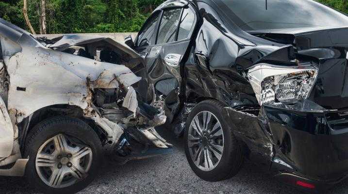 Grey car smashed into a black car