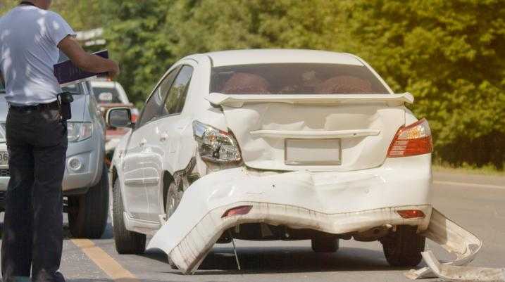 White car with a damaged bumper