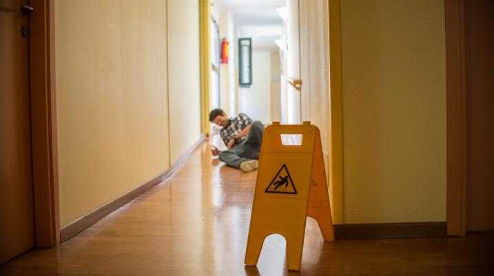 slip and fall sign with a person on the floor