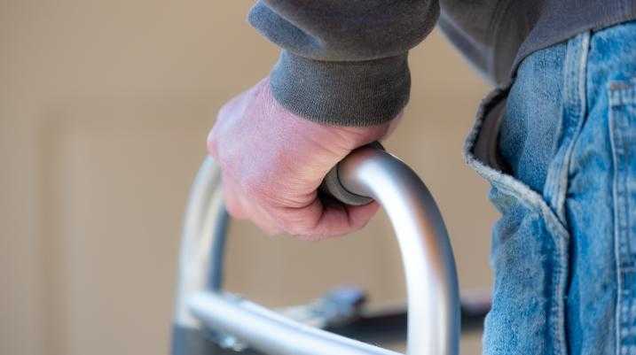 Elderly man using a walker