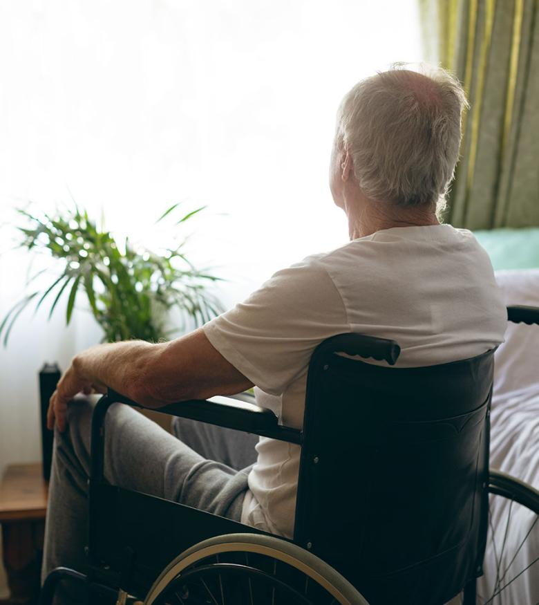 Elderly man sitting in wheelchair