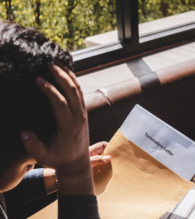 Man looking at Termination Letter