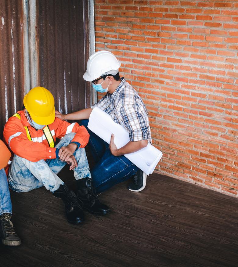 Construction workers sitting upset