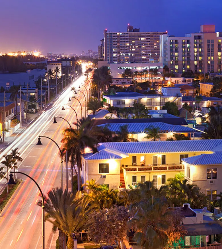 Twilight view of Hollywood, Florida, with lit streets and high-rises, guided by the expertise of local personal injury lawyers.