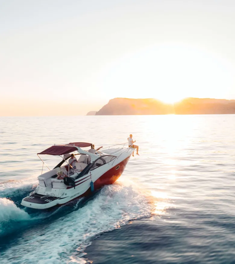 Naples Maritime Attorneys - boat in the ocean with sunset